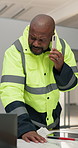 Builder, phone call and man with laptop in building, discussion and planning for renovation project. Reading, paperwork and mature black person with mobile, talk and happy for property development