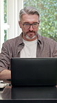 Typing, man and laptop in home office for remote work, manual data entry or invoice vouching. Tech, mature accountant or compare receipt for accuracy, expense processing or audit trail for tax in WFH