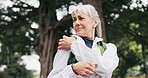 Hiking, break or old woman in nature with shoulder pain, joint injury or burnout in fitness activity. Discomfort, bokeh or senior person with ache, wellness risk or arm strain in retirement trekking.