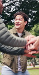 Smile, students and hand stack for education, scholarship and motivation for new semester. Happy, people and huddle at park for celebration, acceptance and study inclusion for academic achievement