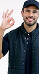 Logistics, face and happy man with OK sign, good job and positive feedback with yes gesture. Smile, portrait and courier with hand emoji, approval and supply chain agreement on studio background.