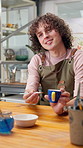 Pottery, teaching and happy man with art for creative class, ceramic design or handy craftsmanship. Male person, educator or instructor with cup or sample for painting technique or porcelain project