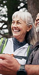 Senior, couple or laughing with phone in nature for navigation, online travel app or adventure. Active, elderly man and woman with smile or technology for outdoor humor, comedy or trekking in forest