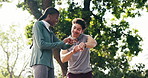 Fitness, park and couple with smart watch, high five and celebrate for exercise, workout and goals. Interracial, outdoor and man with woman with tech, app and stats for training, wellness and health