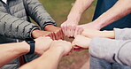 Circle, friends and hands with fist bump at park for social connection, solidarity and community. Unity, people or huddle together with gesture for friendship cohesion, belonging or inclusion outdoor