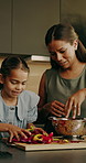 Mother, child and helping at house for cooking, meal prep and healthy food with vegetables. Smile, woman and daughter in kitchen with ingredients, culinary skills and family time for homemade lunch