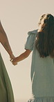 Mother, holding hands and outdoor with child for safety, bonding or relationship security on journey. Back, woman and daughter in nature for travel support, protection and family connection on walk