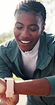 Happy, fitness and black woman with watch for outdoor workout, tracking or schedule in nature. Active, female person or checking wristwatch with smile for monitoring exercise, break or rest in forest