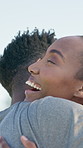 Outdoor, couple and hug with smile, love and bonding with partner and laughing together on weekend. Black people, embrace and connection with spouse on break, happiness and relationship commitment