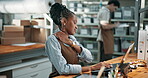 Shipping, woman and shoulder pain with laptop in office, tension or injury at courier facility. Tech, burnout or pressure with supply chain manager, muscle cramp and overworked at logistics startup