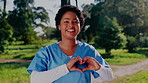 Happy, face and caregiver outdoor with heart hands for support, friendly and medical service. Healthcare, portrait and woman with emoji for kindness, trust and care for career at nursing home