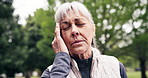 Senior, woman and fitness with headache in park for outdoor strain, anxiety or mental health. Tired, elderly or female person with sore ache or migraine for fatigue, pressure or discomfort in nature