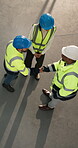 Construction, greeting and team on site with handshake, partnership deal or contractor welcome. Above, people and supervisor with shaking hands, introduction and collaboration in industry opportunity