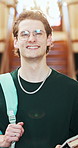 Face, student and laugh in college with backpack, scholarship opportunity and future for education. Happy, man and glasses in university with bag, study grant and positive attitude for learning.