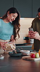 Couple, breakfast and video recording in kitchen with meal prep, influencer and tutorial for cereal. Married, man and woman talk in home with oats recipe, content creation and social media for vlog.