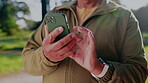 Hands, phone and old man outdoor with digital app for social media, connection and communication. Male user, senior platform and online subscription for mental stimulation or typing text at park