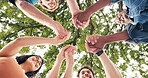 Happy, friends and holding hands at park for support, social connection and solidarity in community. Low angle, people and bonding together in circle for friendship unity, belonging and trust outdoor