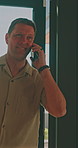 Phone call, smile and man in house, walking and communication with contact after work or networking. Home, arrival and happy person with bag, discussion and chat with mobile and talking on break