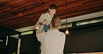 Dad, air and playing with child in home for holiday break, weekend or bonding together with son. Fun, father and lifting kid up with smile for airplane, flying imagination or childhood in house