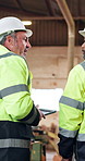 Carpenter, team and discussion in workshop with manufacturing advice, planning and collaboration. Mature men, talk and brainstorming in factory with tablet, woodwork production and project supervisor