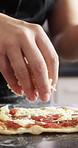 Baking, pizza and hands of chef with cheese in restaurant for catering with dough for meal. Ingredients, cooking and culinary worker with food production for Italian cuisine in kitchen at diner.