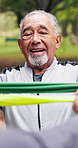 Stretching, fitness and old man in park with resistance band, exercise and muscle strength. Happy, outdoor and senior person with equipment, trainer and breathe for workout, mobility and wellness
