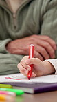 Hands, child and person at house with drawing, coloring stationery and art activity for education. Kid, writing and family support in home with sketch, crayon control and creative artwork for project