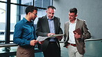 Paperwork, research and businessmen with tablet in meeting, teamwork or financial report on website. Actuary, collaboration and people with tech, risk management and talking with project in office