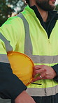 Construction, hands and hardhat outdoor for safety, protection gear and equipment on building site. PPE, man and engineer with risk control, hazard prevention and compliance in industrial industry.