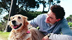 Smile, man and playing at park with dog, affection and loyal companion for animal interaction. Happy, person and petting in nature with golden retriever, pet appreciation and foster care for bonding