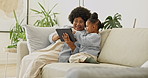 Happy, grandmother and child reading in living room with tablet, conversation and ebook for learning. Senior black woman, girl grandchild and discussion in home with tech, bonding and storytelling.