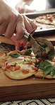 People, hands and dining with pizza cutter for fast food, social gathering or meal serving in home. Pastry chef, cutting board and slice with dairy snack or cuisine for baked dinner together in house