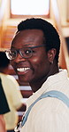 Education, face and man with smile in college, laugh and confident for academic growth and learning. University student, knowledge and person with glasses, portrait and happy for study opportunity