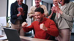 Employees, applause and happy man winning with laptop in office for achievement or team success. Excited, male person and fist pump with colleagues clapping on computer for good news in workplace
