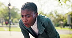 Fitness, break and black woman in park with sweating, cardio fatigue and rest with outdoor practice. Bokeh, dedication and athlete with breathing, training pause and exercise burnout with recovery.