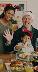 Parents, children and wave with Christmas lunch for holiday tradition, memories and bonding together. Face, happy people and interracial family in home with kids, food or festive for xmas celebration