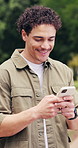 Student, man and laugh in college with phone, internet joke and funny relatable meme for education. Happy, person and typing outdoor in university with tech, text message and humor on social media.