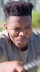 Fitness, power or athlete with battle ropes, outdoor workout or strength training in intense routine. Serious, wellness or black man with equipment, resistance exercise or endurance for muscle growth