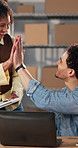 Logistics, team and high five in office with laptop, achievement and manager satisfaction for sales. Happy, people and celebration in small business with computer, ecommerce success or collaboration.