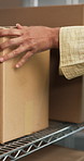 Hands, person and shelf in warehouse with box, inspection and dispatch order for distribution. Employee, packing or package in storage for incoming inventory, organizing stock and commercial shipping