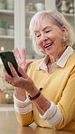 Video call, wave or old woman in house with phone, online connection or hello gesture in kitchen. Happy, talking or senior person with tech, digital communication or friendly greeting on virtual app.