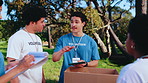 Volunteer, team and checklist with boxes in park for donation or outdoor charity organization. Man, people or NGO group with tablet, packages or clipboard for community service or outreach in nature