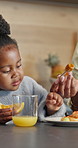Mother, serving and child at house for breakfast, healthy fruit and vitamin c with dessert. Hands, woman and help daughter in kitchen with maple syrup, citrus orange and homemade pancakes for brunch