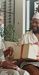 Happy, couple and Christmas at house with gift box, love and romantic surprise for xmas celebration. Smile, African people or exchange in home with present, thank you and holiday tradition of festive