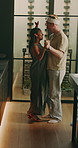 Christmas, cleaning and couple with dance in home for chores, housekeeping and hygiene. Marriage, happy and man with woman with spray bottle, mop and music for house for holiday, bonding and love