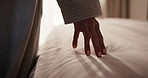 Hands, woman and bedroom sheet in hotel for fabric quality, soft and comfort on luxury vacation. Person, touch and guest feeling bed for texture, check cleanliness or duvet inspection on holiday