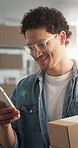 Ecommerce, man and package in office with phone, glasses and smile with next day delivery for order. Happy, person and logistics in small business with tech, inventory management or efficient courier