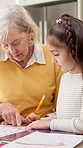Homework, grandparent and girl in kitchen with help, childcare and support with homeschool activity. Education, grandmother or grandchild with task aid, family guidance or assistance in home learning