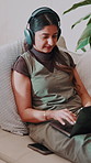Home, music and woman with laptop for remote work, song writer or typing for lyrics composition. Computer, headphones and happy freelancer on couch with rhythm, production research and audio editing