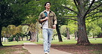 Man, student and walk at park for education, new semester and scholarship for studying abroad. Below, male person and smile in nature for exchange program, academic bursary and learning opportunity
